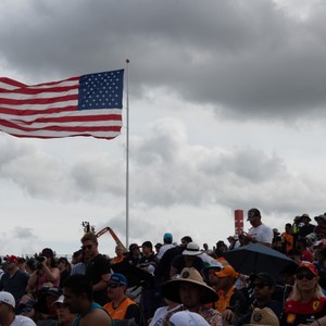 a crowd of people holding a flag