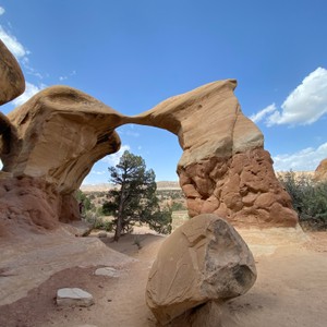 a large rock formation with Devil's Garden in the background