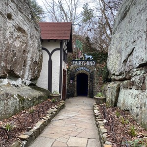 a stone walkway with a stone building