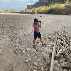 a person taking a picture of a beach