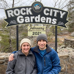 a couple of men standing under a sign