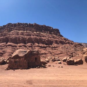 a rocky mountain with a building