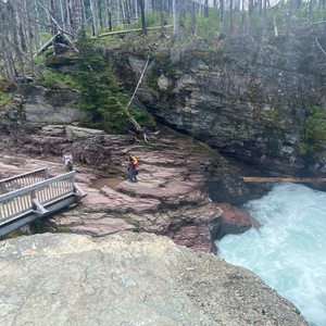 a person standing on a rock ledge