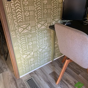 a chair with a patterned wallpaper