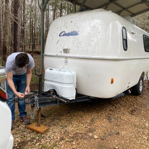 a person working on a white trailer