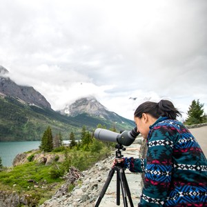 a person looking through a telescope