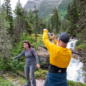 a man taking a picture of a woman with a camera