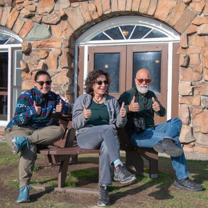 a group of people sitting on a bench in front of a building