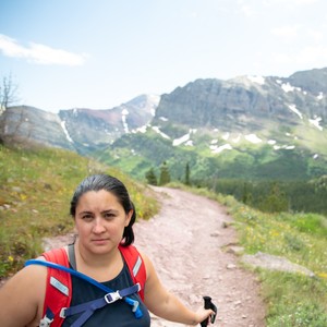 a person on a trail in front of a mountain