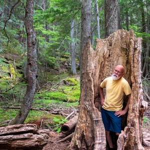 a man standing next to a tree