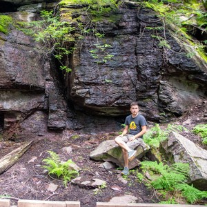 a person sitting on a rock