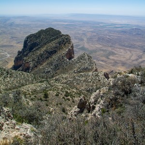 a rocky mountain with a valley below