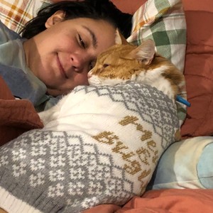 a person lying down with a cat