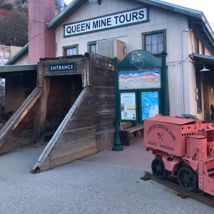 a building with a green door and a red truck parked outside