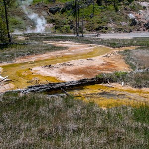 a large geyser in a rocky area