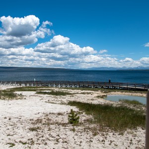 a beach with a pier and water