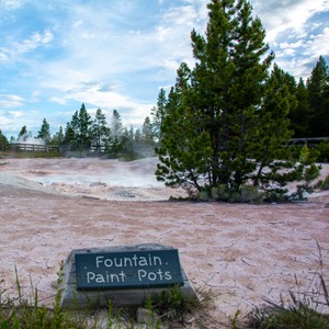 a sign in front of a river