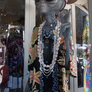 a mannequin wearing a black and gold dress and a necklace