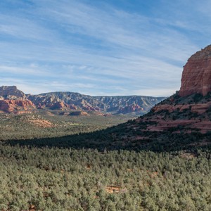 a grassy valley with mountains in the background