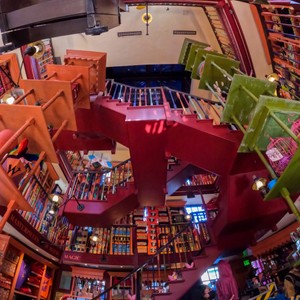 a room with a red and green structure and a staircase